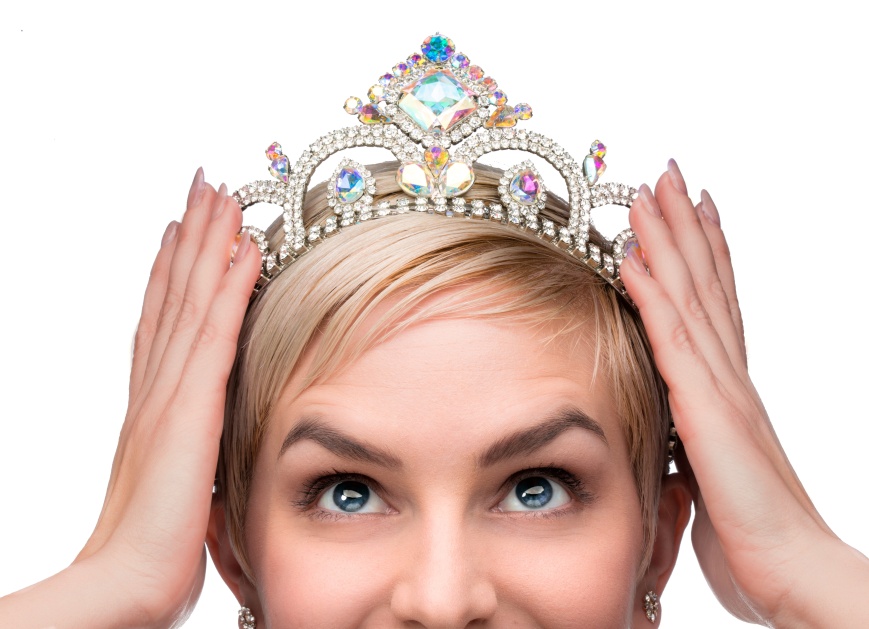 Beauty queen pageant winner placing tiara on head celebrating individuality independence courage and high self esteem